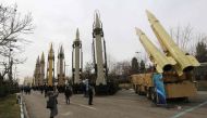 (FILES) A file photo taken on February 2, 2019, shows Iranians visiting a weaponry and military equipment exhibition in the capital Tehran, organised on the occasion of the 40th anniversary of the Iranian revolution. AFP / Atta Kenare 