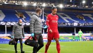 Soccer Football - Premier League - Everton v Liverpool - Goodison Park, Liverpool, Britain - October 17, 2020 Liverpool's Virgil Van Dijk receives medical attention after sustaining an injury Pool via REUTERS/Laurence Griffiths