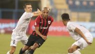 Al Rayyan's Yacine Brahimi (centre) vies for the ball with Al Wakrah players during yesterday's match.