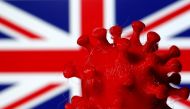 A 3D-printed coronavirus model is seen in front of a British flag on display in this illustration taken March 25, 2020. REUTERS/Dado Ruvic/Illustration/File Photo