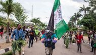Protesters march at Alausa, the Lagos State Secretariat, in Lagos on October 20, 2020, after the Governor of Lagos State, Sanwo Olu, declared 24-hour curfew in Nigeria's economic hub Lagos as violence flared in widespread protests that have rocked cities 