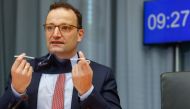 (FILES) In this file photo taken on September 22, 2020 German Health Minister Jens Spahn takes off his face mask as he takes his seat prior to a meeting of the Franco-German Parliamentary Assembly on September 22, 2020 in Berlin. German Health Minister Je