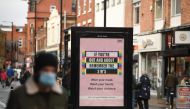 People wearing masks because the novel coronavirus pandemic walk in the high street in Leigh, Greater Manchester, northwest England on October 22, 2020 ahead of new coronavirus restrictions coming into force in the area. AFP / Oli SCARFF