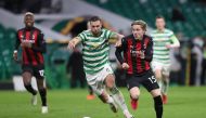AC Milan's Norwegian midfielder Jens Petter Hauge (R) vies with Celtic's Scottish defender Jack Hendry and scores his team's third goal during the UEFA Europa League 1st round group H football match between Celtic and AC Milan at Celtic Park stadium in Gl