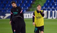 Barcelona's Spanish defender Gerard Pique (L) and Barcelona's Argentine forward Lionel Messi warm up before the Spanish League football match between Getafe and Barcelona at the Coliseum Alfonso Perez stadium in Getafe, south of Madrid, on October 17, 202