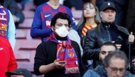 March 7, 2020 A Barcelona fan wears a mask before the match due to the recent coronavirus outbreak REUTERS/Albert Gea/File Photo