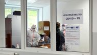 A healthcare worker collects a swab sample from a person at a COVID-19 testing site at the municipal office as the spread of the coronavirus disease (COVID-19) continues, in Oravsky Podzamok, Slovakia October 23, 2020. REUTERS/Radovan Stoklasa