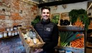 Alex Stephens, the owner The Farm Fresh Market, poses for a picture at his farm shop that has offered free lunches to children who need it over half term, after reacting to footballer Marcus Rashford's online post, as the spread of coronavirus diseases (C