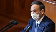 Japan's Prime Minister Yoshihide Suga wearing a face mask, gives his policy speech during an extraordinary session at the lower house of parliament in Tokyo on October 26, 2020. Suga sets 2050 deadline for carbon neutrality. / AFP / Kazuhiro NOGI
