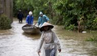 Residents wade along a flooded road at a village in Quang Tri province, Vietnam October 20, 2020. Picture taken October 20, 2020. Yen Duong/International Federation of the Red Cross (IFRC)/Handout via REUTERS