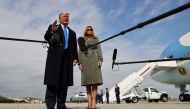 U.S. President Donald Trump talks to reporters with first lady Melania Trump while boarding Air Force One as they depart Washington for campaign travel to Michigan at Joint Base Andrews, Maryland, U.S., October 27, 2020. REUTERS/Jonathan Ernst
