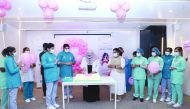 Employees of Naseem Medical Centre cutting a cake during the awareness event.