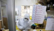 A member of the medical staff dressed in a protective suit prepares medicine for coronavirus disease patients inside the COVID-19 ICU of Machakos Level 5 Hospital, in Machakos, Kenya October 28, 2020. REUTERS/Baz Ratner/File Photo