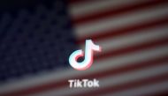 FILE PHOTO: A reflection of the U.S. flag is seen on the sign of the TikTok app in this illustration picture taken September 19, 2020. REUTERS/Florence Lo/File Photo
