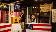 Tom Tillotson drops voters ballots into the ballot box at the Hale House at the historic Balsams Resort during midnight voting as part of the first ballots cast in the United States Presidential Election in Dixville Notch, New Hampshire on November 3, 202