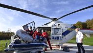 Medics carry a patient infected with Covid-19 into a helicopter as he is transferred from the university hospital in Liege to Koln, Germany, on November 3, 2020. AFP / BELGA / ERIC LALMAND
