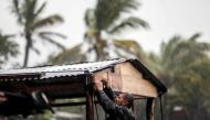 A man protects his beach house as Hurricane Eta approaches in Bilwi, Puerto Cabezas, Nicaragua, on November 2, 2020. AFP / INTI OCON
