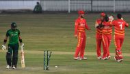 Zimbabwe's Donald Tiripano (2R) celebrates with teammates after taking the wicket of Pakistan's Mohammad Rizwan (L) during the third one-day international (ODI) cricket match between Pakistan and Zimbabwe at the Rawalpindi Cricket Stadium in Rawalpindi on
