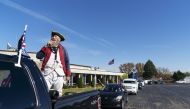 Trump supporter Matthew Woods, dressed as a Continental Army soldier, leads a Trump Train Rally on Election Day through the streets of Warren, Mich., Tuesday, Nov. 3, 2020. (AP Photo/David Goldman)