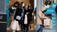 Shoppers are seen leaving a Primark store with bags, after new nationwide restrictions were announced during the coronavirus disease (COVID-19) outbreak in Liverpool, Britain, November 4, 2020. Reuters/Phil Noble