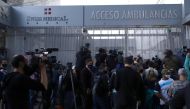 Reporters and fans of Argentine soccer great Diego Maradona gather outside the clinic where he will be undergoing surgery, in Olivos, on the outskirts of Buenos Aires, Argentina November 3, 2020. REUTERS/Matias Baglietto