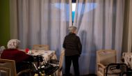 Elderly residents gather in a common area at the 'Torre della Rocchetta' retirement home in Albuzzano, near Pavia, Northern Italy, on November 3, 2020. / AFP / Marco Bertorello