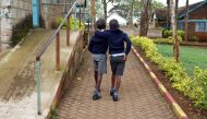 Visually impaired pupils hold on to each other for confidence as they walk after attending a lesson, amid the spread of the coronavirus disease (COVID-19) at the Thika school for the blind in Thika town of Kiambu county, Kenya October 29, 2020. Picture ta