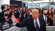 U.S. President Donald Trump's campaign staff applaud him as he waves after speaking to them while visiting his presidential campaign headquarters on Election Day outside of Washington in Arlington, Virginia, U.S., November 3, 2020. REUTERS/Tom Brenner
