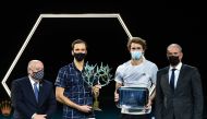 Russia's Daniil Medvedev (2nd L), flanked by President of the French Tennis Federation (FFT) Bernard Giudicelli (L) and Director of the Paris Masters tournament Guy Forget (R), celebrates with the trophy after winning his men's singles final tennis match 