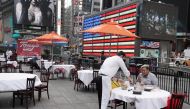 FILE PHOTO: Servers package food at a table at a pop up restaurant set up in Times Square for 'Taste of Times Square Week' during the coronavirus disease (COVID-19) pandemic in the Manhattan borough of New York City, New York, U.S., October 23, 2020. REUT