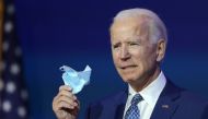 WILMINGTON, DELAWARE - NOVEMBER 09: U.S. President-elect Joe Biden holds a protective mask as he speaks to the media after receiving a briefing from the transition COVID-19 advisory board on November 09, 2020 at the Queen Theater in Wilmington, Delaware. 