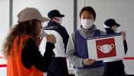 Officials wearing protective masks conduct a test session of screening measures for Tokyo Olympic games spectators, including coronavirus disease (COVID-19) countermeasures at Tokyo Big Sight, Japan October 21, 2020. REUTERS/Issei Kato/File Photo