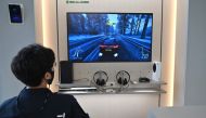 A staff member plays on Microsoft's Xbox Series X gaming console at a flagship store of SK Telecom in Seoul on November 10, 2020. / AFP / Jung Yeon-je