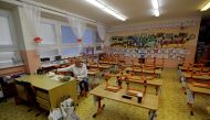 A teacher prepares school supplies inside an empty classroom at a closed school in Prague, Czech Republic, October 14, 2020. Czech Republic will reopen the first and second grades of elementary schools on Nov. 18 as the latest data show a drop in new coro