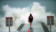 A lifeguard walks to the end of the jetty after closing it down to surfers before the arrival of Tropical Storm Eta in Bradenton Beach, Florida, U.S. November 11, 2020. REUTERS/Steve Nesius/File Photo