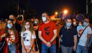 This photograph taken on September 15, 2020, shows VMRO DPMNE opposition leader Hristijan Mickovski (C) wearing a T-shirt with an image of revolutionary figure Goce Delchev, as he stands with others during an anti-government protest in Skopje. AFP / Rober