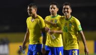 (L-R) Brazil's Thiago Silva, Marquinhos and Roberto Firmino celebrate after defeating Venezuela 1-0 in their closed-door 2022 FIFA World Cup South American qualifier football match at Morumbi Stadium in Sao Paulo, Brazil, on November 13, 2020. AFP / Pool 