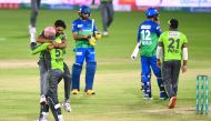 Lahore Qalandars’ cricketers celebrate after defeating Multan Sultans in their Pakistan Super League match at the National Stadium in Karachi, yesterday.