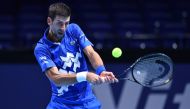 Serbia's Novak Djokovic returns against Argentina's Diego Schwartzman in their men's singles round-robin match on day two of the ATP World Tour Finals tennis tournament at the O2 Arena in London on November 16, 2020. / AFP / Glyn KIRK