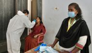 A health worker conducts a rapid antigen test for Covid-19 coronavirus on a lecturer at college premises as the state government education department directed the reopening of degree colleges after several months of closure in wake of the coronavirus pand