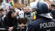 A demonstrator wears a white mask during a protest against the government's coronavirus disease (COVID-19) restrictions, near the Reichstag, the seat of Germany's lower house of parliament Bundestag, in Berlin, November, 18, 2020. Reuters/Christian Mang