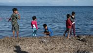 FILE PHOTO: Children stand next to the sea at the Kara Tepe camp for refugees and migrants on the island of Lesbos, Greece, October 14, 2020. REUTERS/Elias Marcou