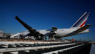 Air France employees load a Boeing 777 cargo plane with Active Temperature Control containers carrying rabies vaccines at Charles de Gaulle airport in Roissy, near Paris as the coronavirus disease (COVID-19) outbreak continues in France November 18, 2020.