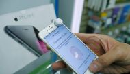 FILE PHOTO: A man holds an iPhone 6 in a mobile phone shop in Moscow, Russia, September 26, 2014. REUTERS/Maxim Shemetov/File Photo
