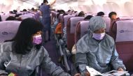 Z.C. Chen, chairman of BenQ, reads the duty-free magazine while wearing a protective outfit on a flight, amid the spread of the coronavirus disease (COVID-19), in Taipei, Taiwan November 19, 2020. REUTERS/Ann Wang