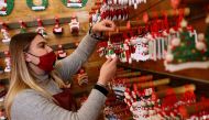 FILE PHOTO: A shop assistant works in a Christmas shop, as the spread of the coronavirus disease (COVID-19) continues, in Rome, Italy November 10, 2020. REUTERS/Guglielmo Mangiapane/File Photo
