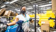 An Amazon.com Inc worker prepares an order in which the buyer asked for an item to be gift wrapped at a fulfillment center in Shakopee, Minnesota, U.S., November 12, 2020. Amazon.com Inc/Handout via Reuters
