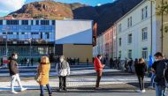 People line up on November 20, 2020 outside a Covid testing facility set up at the Rosenbach Civic Center in the Oltrisarco district of Bolzano, South Tyrol, Northern Italy, waiting to undergo a free rapid antigen nasopharyngeal swab test for COVID-19, wi