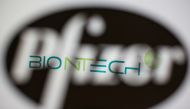 Biontech's logo is seen through a 3D-printed Pfizer logo in this illustration taken November 10, 2020. REUTERS/Dado Ruvic/Illustration/File Photo