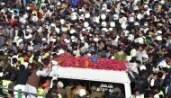 Activists and supporters of Tehreek-e-Labbaik Pakistan (TLP) gather around an ambulance carrying the coffin of Khadim Hussain Rizvi, founder of TLP, during his funeral ceremony in Lahore on November 21, 2020.  AFP / Arif ALI